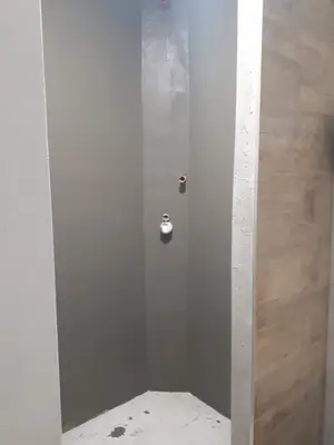 Příprava stěn sprchy před montáží sprchové sestavy.